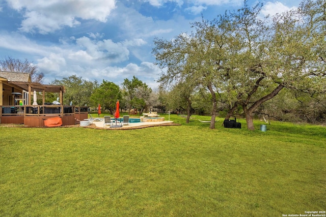 view of yard with a patio, an outdoor pool, and a pergola