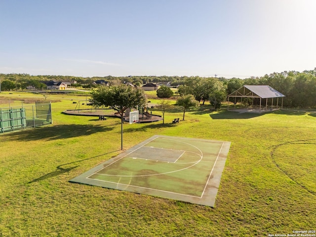 view of basketball court with community basketball court and a yard