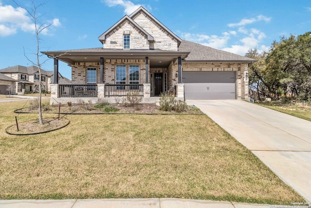 view of front of property featuring a porch, a front lawn, concrete driveway, a garage, and stone siding