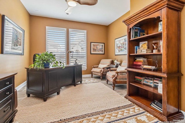 home office featuring a ceiling fan and baseboards