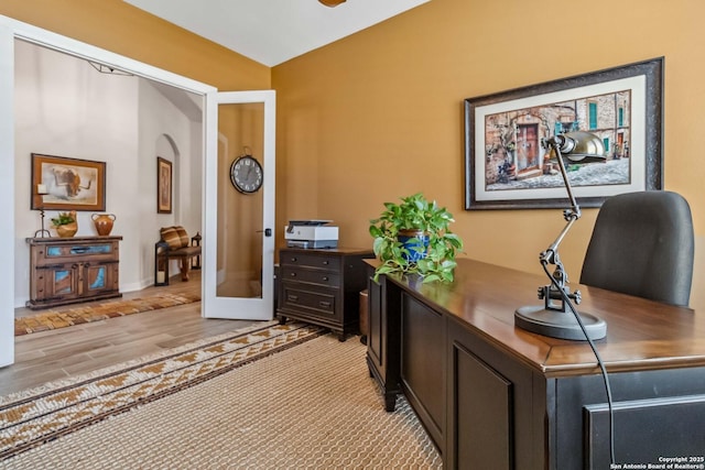 office area with light wood-type flooring, french doors, and baseboards