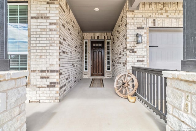 property entrance featuring brick siding