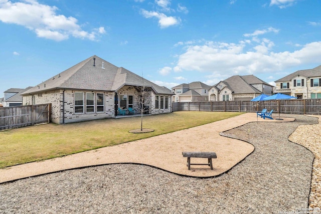 exterior space featuring a patio, a fenced backyard, and a residential view