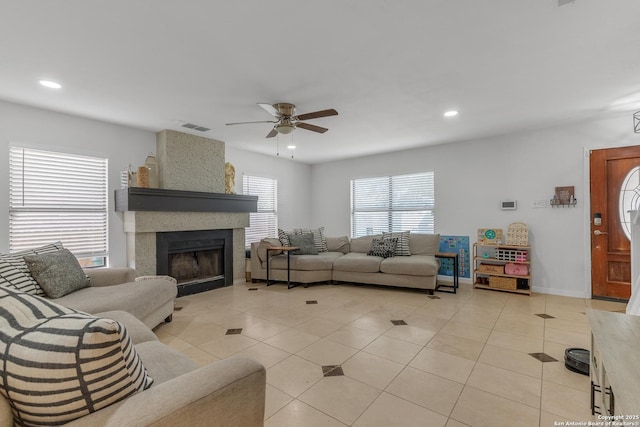 living room with light tile patterned floors, visible vents, recessed lighting, and a large fireplace