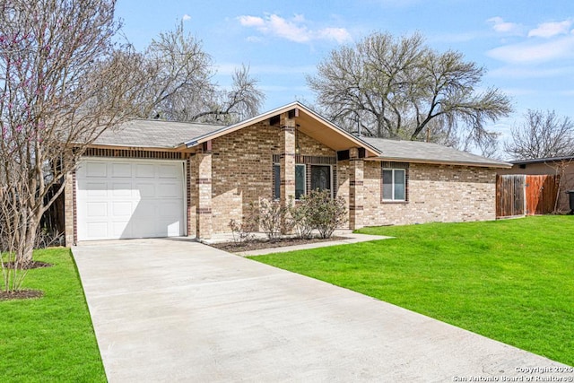 view of front of property featuring a front yard, concrete driveway, brick siding, and a garage