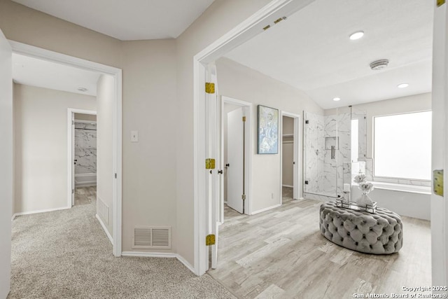 corridor featuring vaulted ceiling, recessed lighting, baseboards, and visible vents