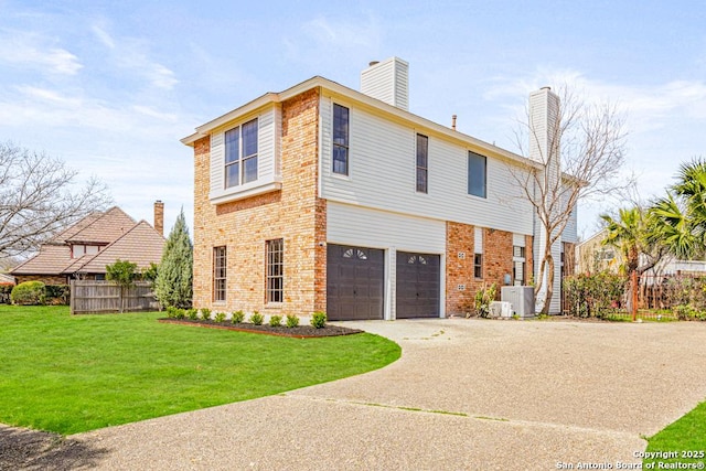 view of front of property with driveway, brick siding, a front lawn, and fence