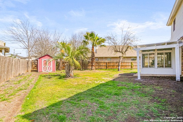 view of yard with an outbuilding, a storage unit, a fenced backyard, and a pergola