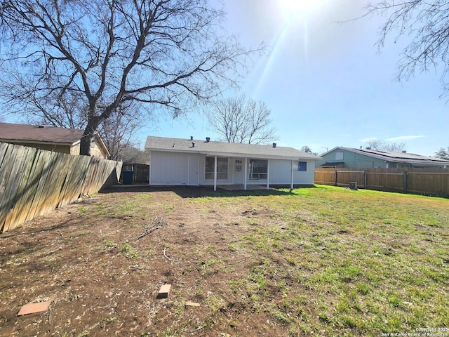 back of property with a yard and a fenced backyard