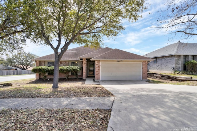 ranch-style home featuring an attached garage, brick siding, driveway, and a shingled roof