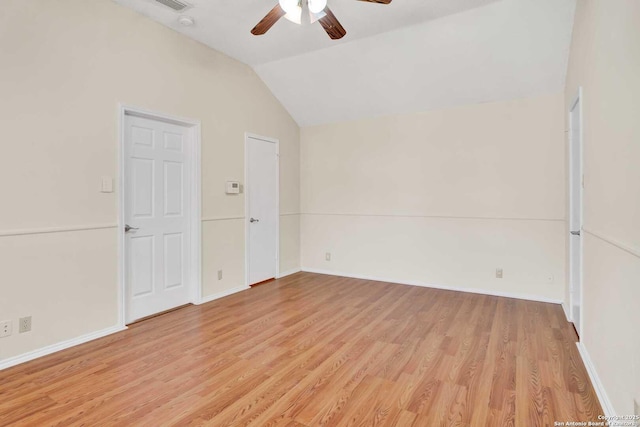 spare room with lofted ceiling, baseboards, light wood finished floors, and ceiling fan