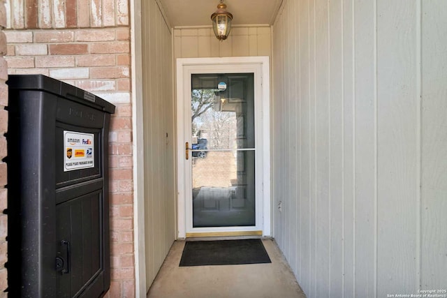 doorway to property with brick siding