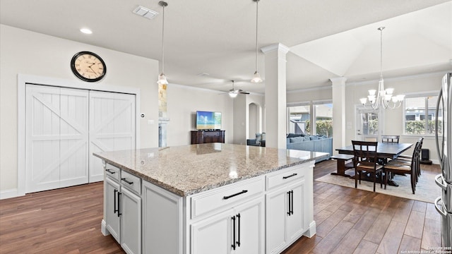 kitchen featuring dark wood-style floors, visible vents, ornate columns, and a healthy amount of sunlight