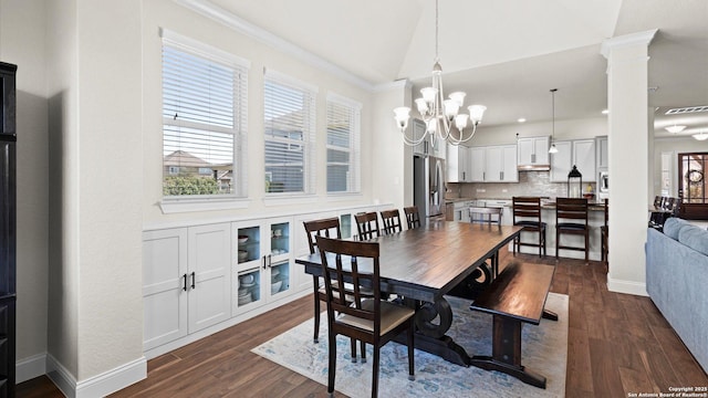 dining area featuring visible vents, baseboards, decorative columns, an inviting chandelier, and dark wood-style floors