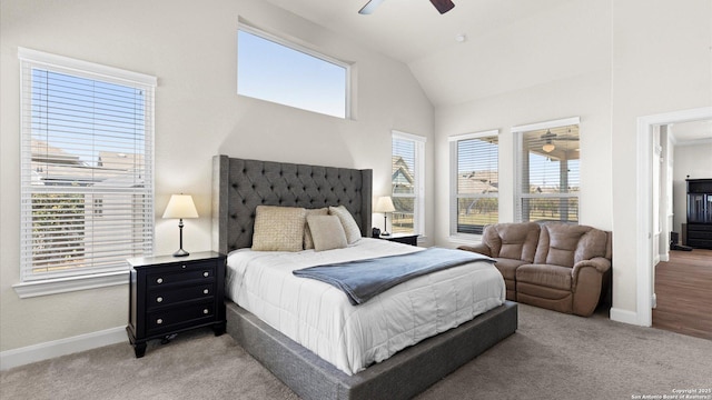 bedroom featuring lofted ceiling, a ceiling fan, baseboards, and light carpet