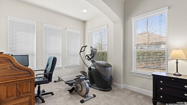 home office featuring arched walkways, recessed lighting, baseboards, and carpet