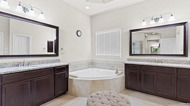 bathroom with a bath, tile patterned floors, two vanities, and a sink