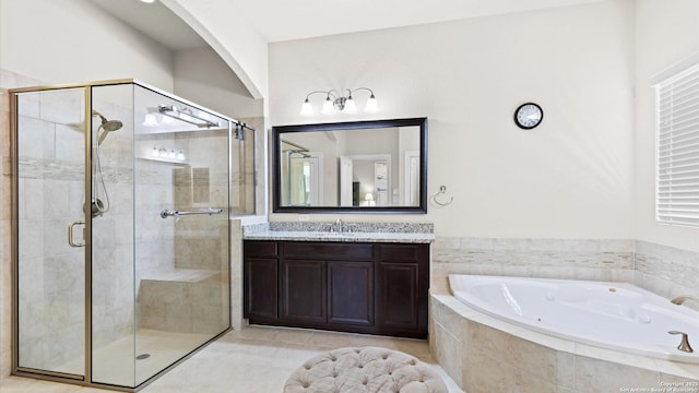 bathroom with tile patterned floors, vanity, a stall shower, and a whirlpool tub