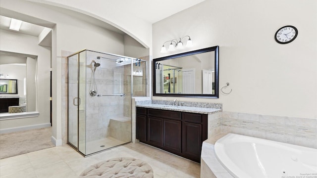 full bathroom with vanity, a shower stall, a jetted tub, and tile patterned floors