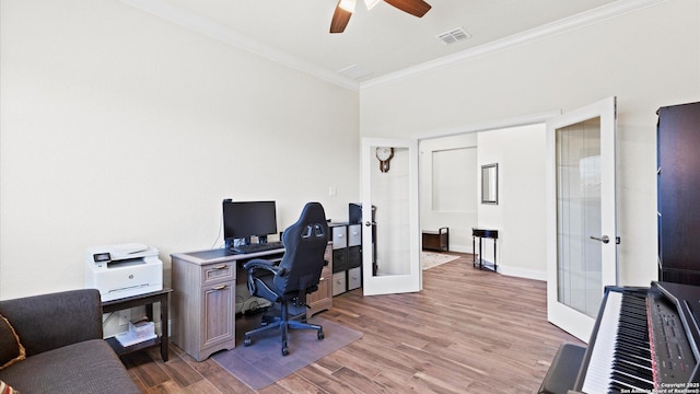 office area with visible vents, ceiling fan, light wood-type flooring, ornamental molding, and french doors