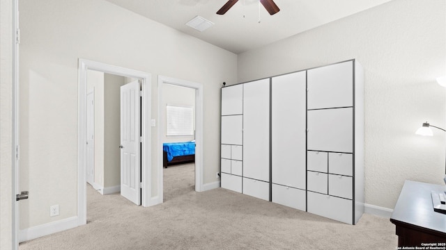 unfurnished bedroom featuring a ceiling fan, carpet flooring, baseboards, and visible vents