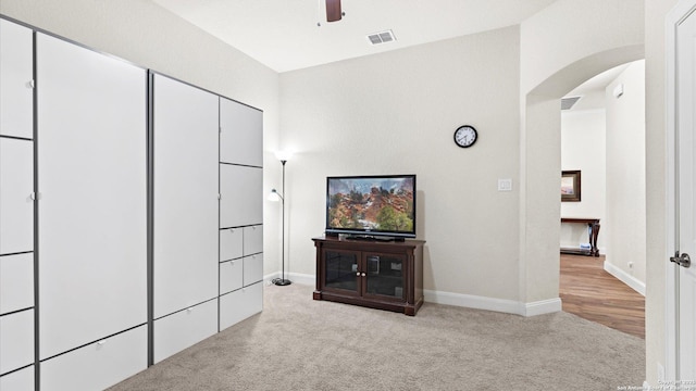 corridor with visible vents, carpet floors, arched walkways, and baseboards