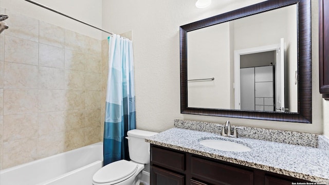 full bathroom with vanity, shower / tub combo, and toilet