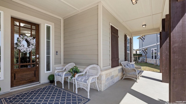 view of exterior entry with a porch