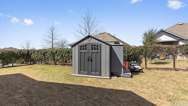 view of shed featuring fence