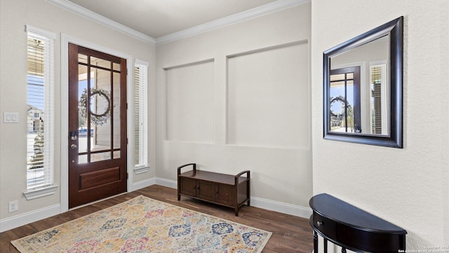 entrance foyer featuring baseboards, wood finished floors, and crown molding