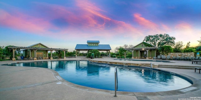 pool with a patio and a pergola