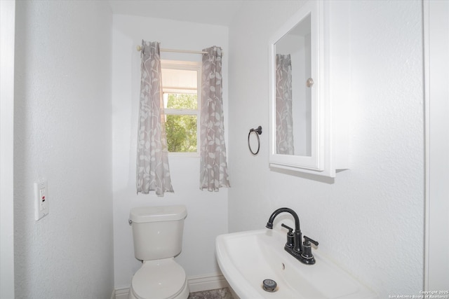 bathroom with toilet and a sink