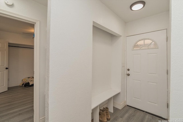 mudroom featuring baseboards and wood finished floors