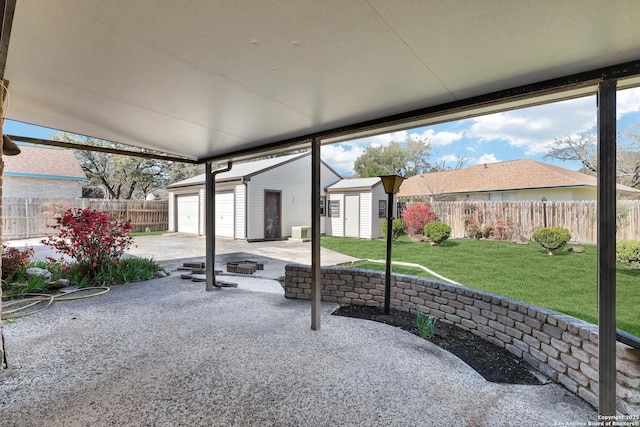 view of patio with an outbuilding and a fenced backyard