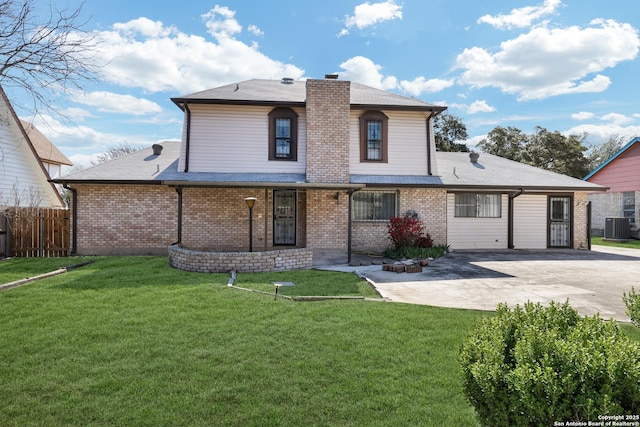 traditional home featuring cooling unit, fence, brick siding, and a patio area