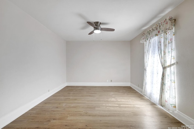 spare room with ceiling fan, baseboards, and wood finished floors