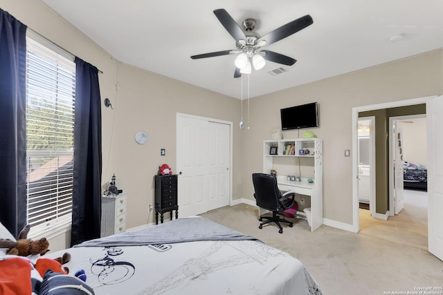 bedroom with a ceiling fan, baseboards, visible vents, and light colored carpet