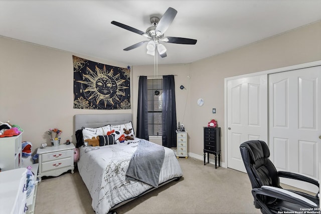 bedroom featuring a ceiling fan, light colored carpet, a closet, and baseboards