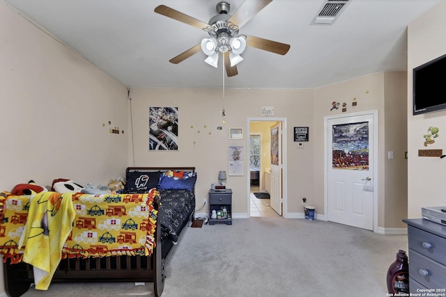 bedroom featuring visible vents, connected bathroom, carpet floors, baseboards, and ceiling fan