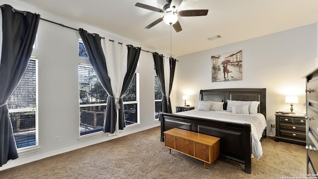 bedroom featuring baseboards, carpet, visible vents, and ceiling fan