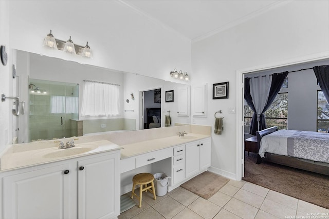 ensuite bathroom featuring a shower stall, a wealth of natural light, tile patterned floors, ensuite bath, and a sink