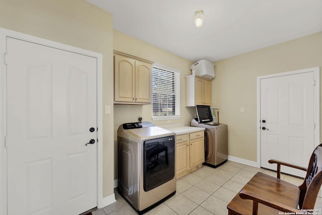 laundry room with washer / dryer, light tile patterned floors, cabinet space, and baseboards