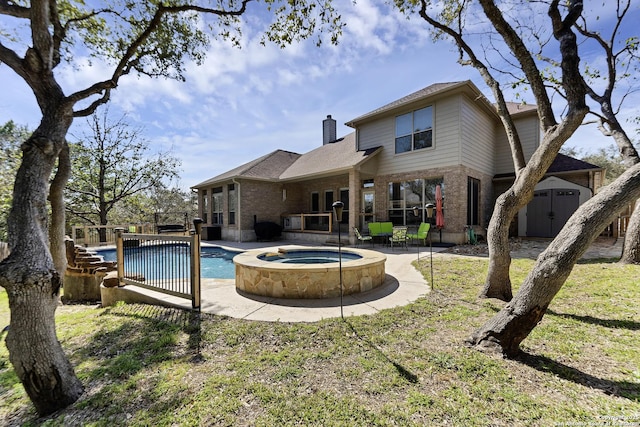 outdoor pool featuring a storage unit, an outbuilding, an in ground hot tub, and a patio area