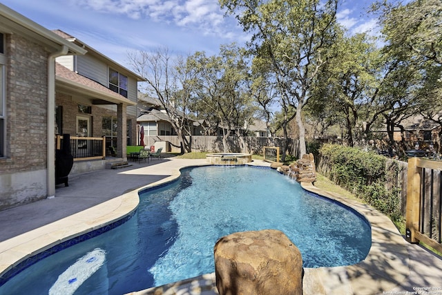 view of swimming pool featuring a fenced backyard, a fenced in pool, an in ground hot tub, and a patio