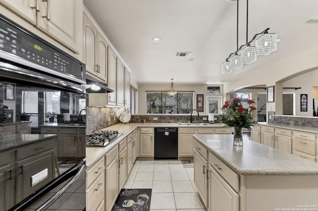 kitchen featuring visible vents, light tile patterned flooring, a sink, black appliances, and tasteful backsplash