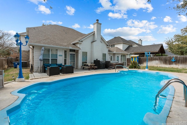 view of pool featuring a patio area, an outdoor living space, a fenced backyard, and a fenced in pool