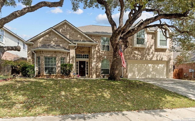 view of front of property featuring a front yard, a garage, brick siding, and driveway