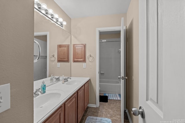 full bath featuring tile patterned floors, double vanity, and a sink