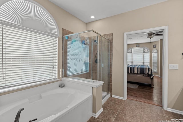 ensuite bathroom featuring ensuite bathroom, a shower stall, a bath, ceiling fan, and tile patterned flooring