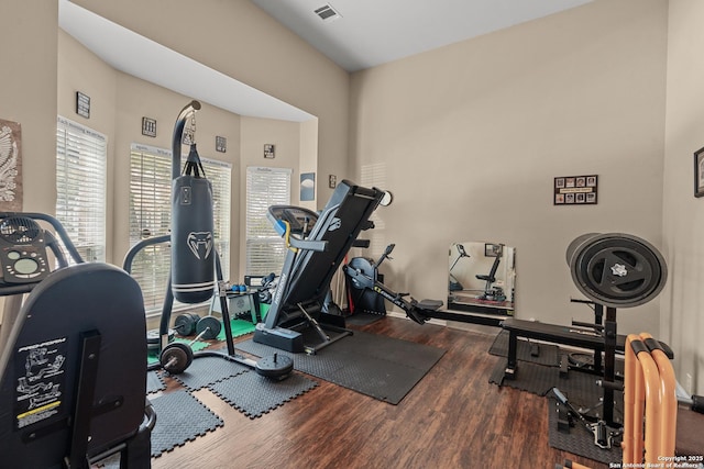 workout area with wood finished floors and visible vents